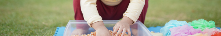 Child playing with a sensory bin